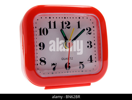 Red plastic travel alarm clock on white background Stock Photo