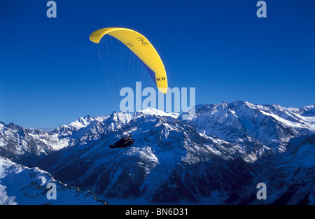 Parasailer gliding over Haslital, Hasli valley, winter, Bernese alps, Switzerland Stock Photo