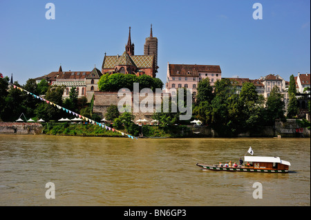 Cable ferry across the river Rhine in Basel (Basle, Bale, Basilea) Switzerland with Basel Munster (Cathedral) in the background Stock Photo