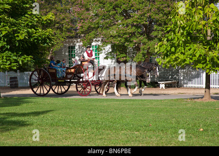 Family taking horse drawn carriage ride at Colonial Williamsburg living history museum in Williamsburg Virginia. Stock Photo