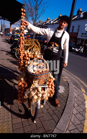 French onion and garlic seller in Lordship Lane, Dulwich, SE22, south east London, England, UK on Saturday market day Stock Photo