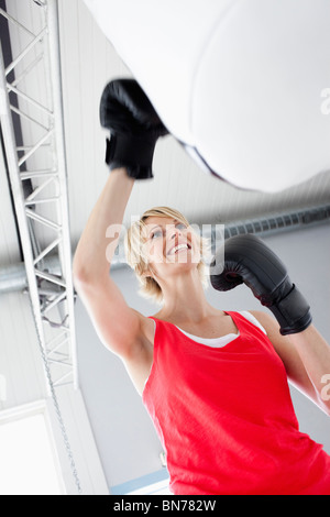 Woman boxing punching bag Stock Photo