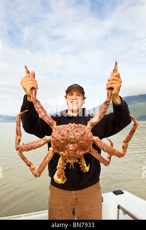 Man holding a king crab Stock Photo - Alamy