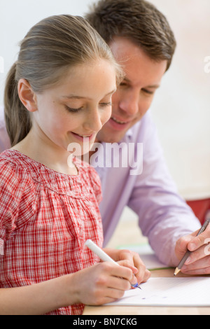 Father and daughter doing homework Stock Photo