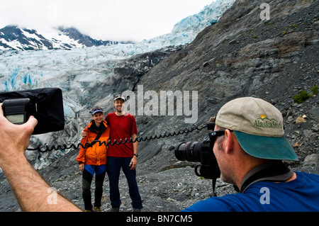 Photographer working with models in front of Shoup Glacier, Shoup Bay State marine Park, Prince WIlliam Sound, Alaska Stock Photo