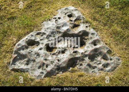 Triangular shaped - by human hand - Sarsen stone outside Wisley Parish Church Surrey  positioned immediately to left of church porch. 2010, 2010s UK HOMER SYKES Stock Photo