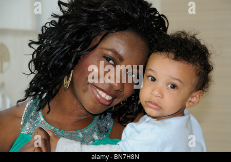 Portrait of a young mother holding her ten month old baby boy Stock Photo