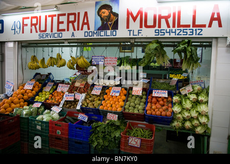 Fixed indoor market stall seller / shop with good / top quality fresh fruit and vegetables. Seville / Sevilla. Spain. Stock Photo
