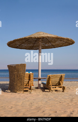 Sun loungers under a sun shade on an Egyptian beach Stock Photo