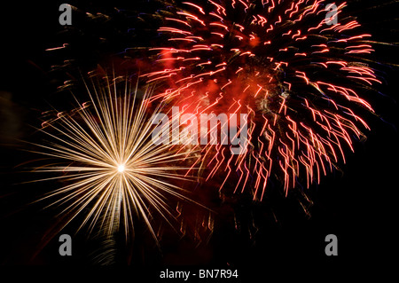Multiple bursts of fireworks light up the night sky on the Fourth of July in Tumwater, Washington. Stock Photo