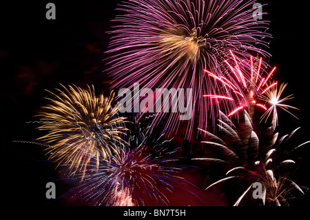 Multiple bursts of fireworks fill the night sky in a dazzling pyrotechnic display on the Fourth of July in Tumwater, Washington. Stock Photo