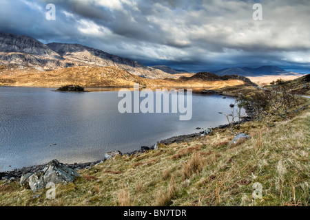 Loch stack, Sutherland in the north of Scotland along the A838 with evening sun on mountains Stock Photo