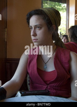 College Student reads Dr. C.G. Jung's "Man And His Symbols" in a Brooklyn cafe. Stock Photo
