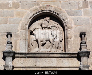 Avila, Avila Province, Spain. Bas-relief of Saint Martin of Tours cutting his cloak in half to share with a beggar, Stock Photo