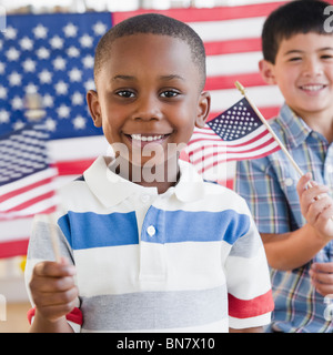 Boys holding small American flags Stock Photo