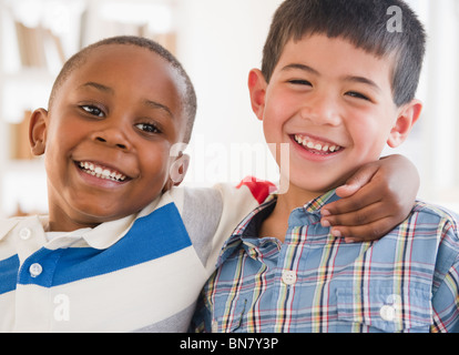 Friends smiling and hugging each other Stock Photo