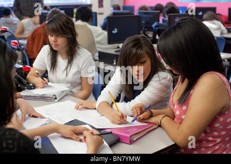 Hispanic high school girls work together on assignment in English class Stock Photo