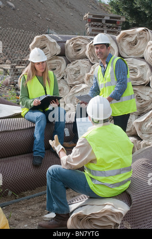 Hispanic construction workers having meeting outdoors Stock Photo