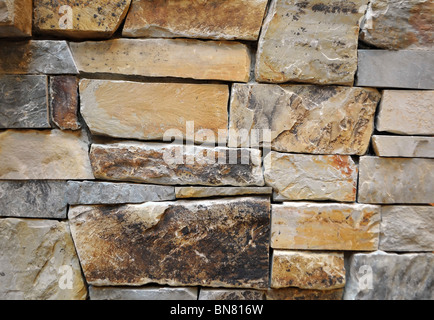 Close up of a stone wall texture. Yellow and brown Stock Photo