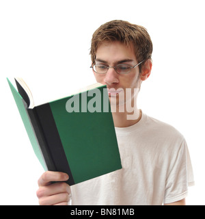 Young white Caucasian male adult reading a small green hardcover book isolated on white background. Stock Photo
