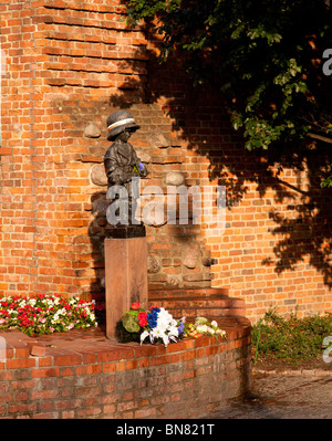 Statue at the Monument to the Little Insurgent in Old Town Warsaw in Poland by the town walls Stock Photo