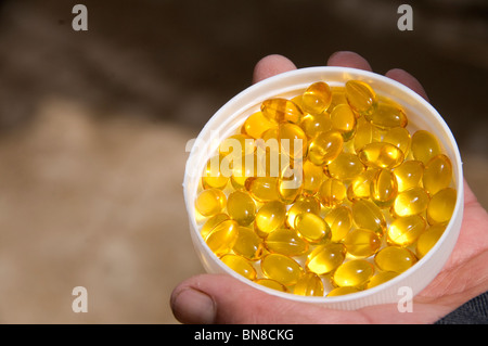 close-up of lid containing yellow cod liver oil tablets Stock Photo