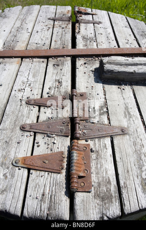 old hinges on decayed wooden lid Stock Photo