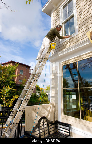 Painter on ladder Skaneateles New York Finger Lakes Region Stock Photo