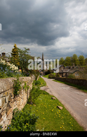 Storm clouds brewing over the village of Edensor in the Peak District National Park Derbyshire East Midlands England Stock Photo