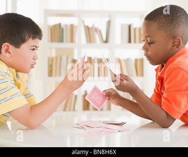 Boys playing cards together Stock Photo