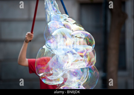 performer blowing giant soap bubbles, Barcelona, Spain. Stock Photo
