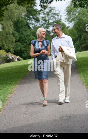 Couple walking in park Stock Photo
