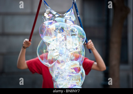 performer blowing giant soap bubbles, Barcelona, Spain. Stock Photo