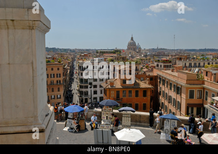 The panoramic view down Via dei Condotti of Rome enjoyed by tourist's beside the Sallustian Obelisk Stock Photo