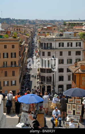 The panoramic view down Via Condotti of Rome enjoyed by tourist's beside the Sallustian Obelisk Stock Photo