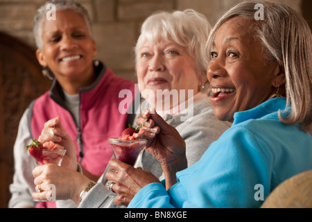 Friends eating dessert in restaurant Stock Photo