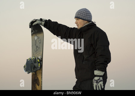 Male snowboarder on a background of a city landscape Stock Photo