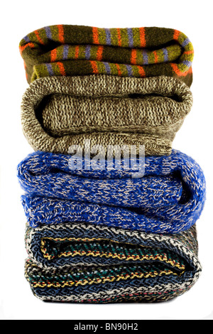 Pile of warm sweaters isolated on white Stock Photo
