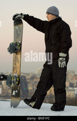 Male snowboarder on a background of a city landscape Stock Photo