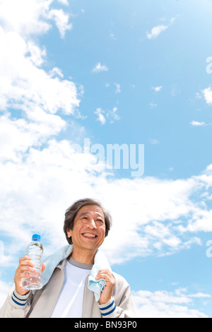 Mature man holding water bottle Stock Photo