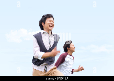 Two young men running Stock Photo