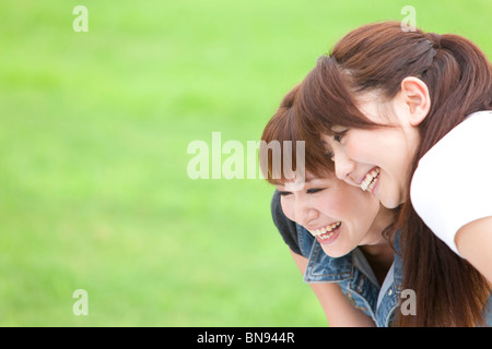 Two Young Women Cuddling Stock Photo