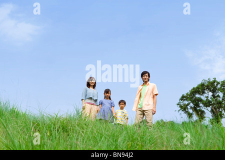 Portrait of family standing in field Stock Photo