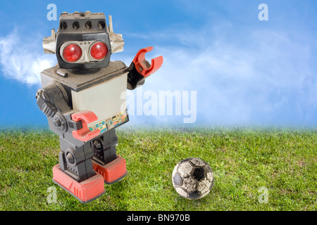 robot soccer player over grass Stock Photo