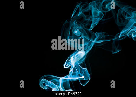 Abstract blue smoke trails on a black background Stock Photo