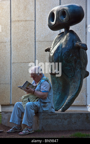 Barcelona, Spain 2009. Tourist sitting on sculpture in front of the famous tourist attraction Joan Miró Museum. Portrait Stock Photo