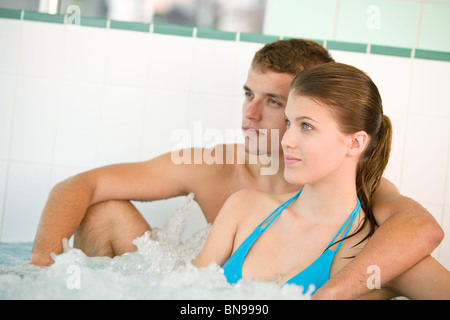 Young loving couple enjoy whirlpool bath in luxury spa Stock Photo