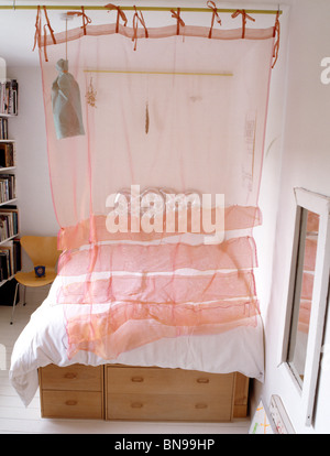 Peach Voile Curtain Screening Single Bed Stock Photo