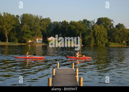 couple in rowing boats on the lake, evening light, Murnau am Staffelsee, Garmisch-Partenkirchen, Oberbayern, Bavaria, Germany Stock Photo