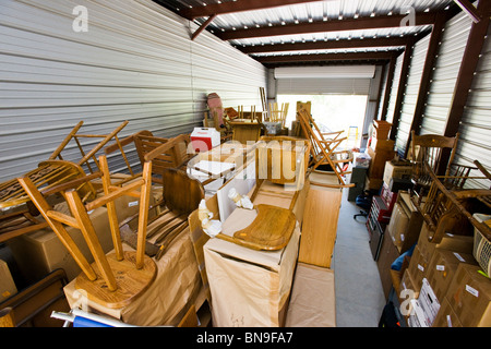 Family personal house hold belongings temporarily stored in a mini storage facility. Stock Photo